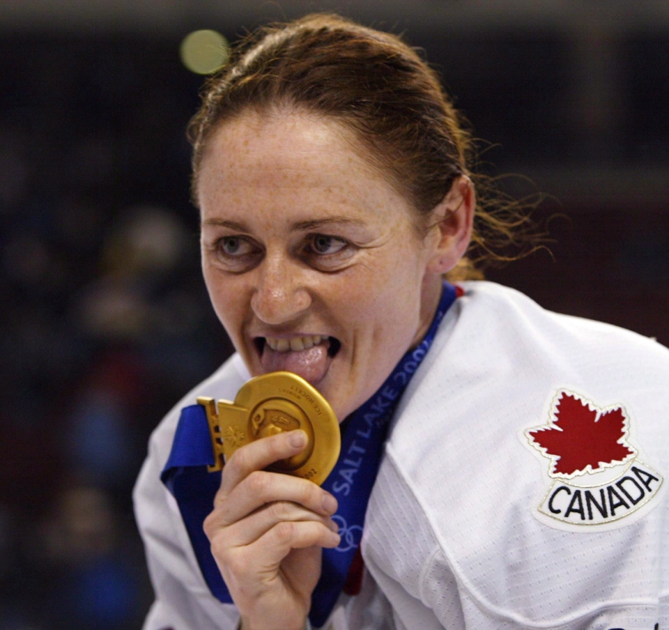 Canadian women&#39;s hockey team member Geraldine Heaney licks her gold medal after their win over the United States at the XIX Olympic Winter Games in Salt ... - image