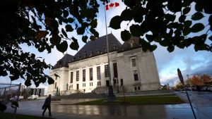 A pedestrian walks past the Supreme Court of Canada in Ottawa, Oct. 18, 2013. (Sean Kilpatrick / THE CANADIAN PRESS)