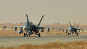 Canadian Armed Forces CF-18 fighter jets taxi to takeoff for a mission over Iraq during Operation Impact, in Kuwait, Thursday, Nov. 13, 2014. (Canadian Forces Combat Camera / Department of National Defence)