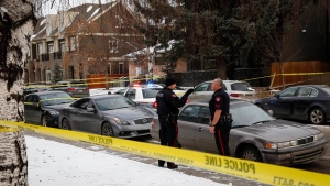 Police attend the scene of a multiple shooting in Calgary, Thursday, Jan. 1, 2015. (Jeff McIntosh / THE CANADIAN PRESS)