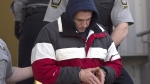 Christopher Burton Phillips is escorted from provincial court in Dartmouth, N.S. on Friday, Jan. 23, 2015. (Andrew Vaughan / THE CANADIAN PRESS)