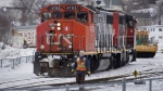 A CN locomotive moves in the railway yard in Dartmouth, N.S. on Feb. 23, 2015. Unifor said it has reached a late night deal with Canadian National Railway to avoid a lockout of 4,800 workers. (Andrew Vaughan / THE CANADIAN PRESS)