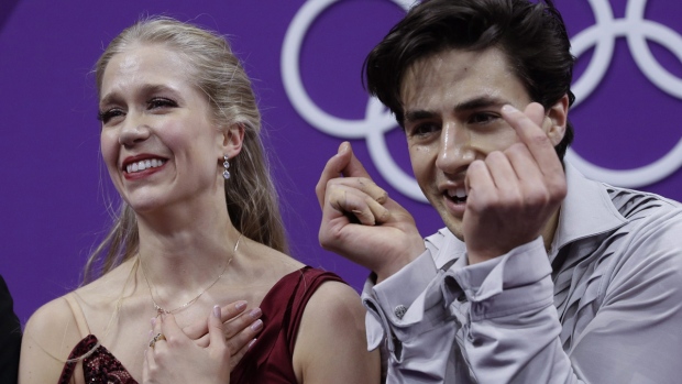 Kaitlyn Weaver and Andrew Poje get their scores