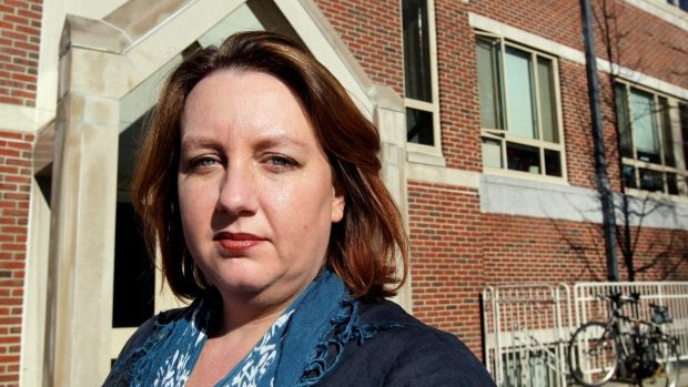 Carrie Twomey, wife of former IRA member Anthony McIntyre, stands outside a building where a federal court hearing was being held at the Boston College Law ... - image