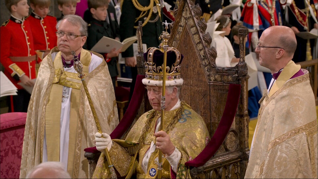 The King is presented with the royal regalia