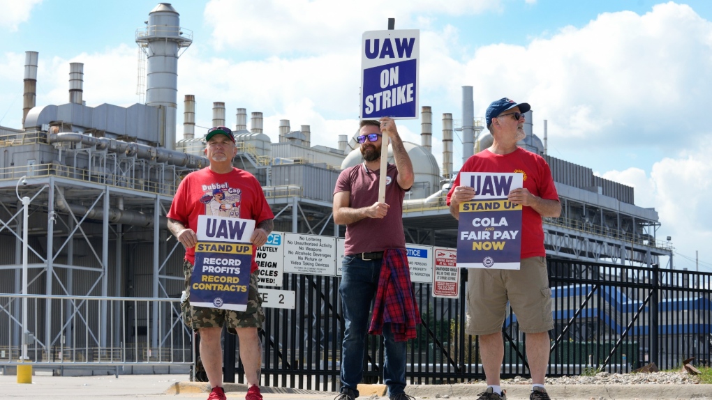 Workers strike at all 3 Detroit automakers, a new tactic to squeeze companies for better pay