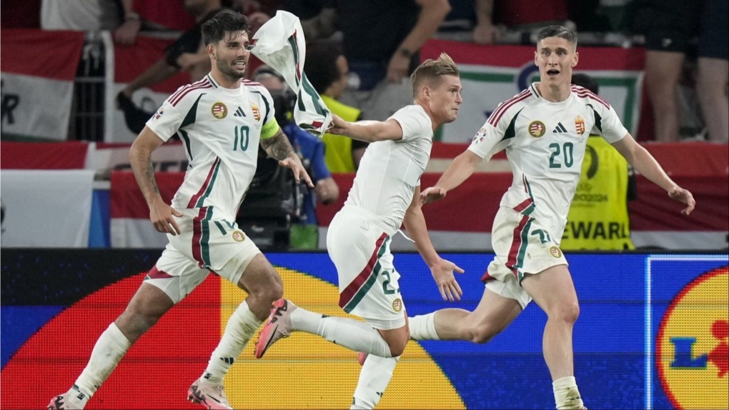 Hungary's Kevin Csoboth, center, celebrates after scoring the opening goal during a Group A match between Scotland and Hungary at the Euro 2024 soccer tournament in Stuttgart, Germany, Sunday, June 23, 2024. (AP Photo/Matthias Schrader)
