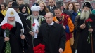 Russian President Vladimir Putin walks alongside religious leaders of various denominations at the Red Square as they go to place flowers at a statue of Minin and Pozharsky, the leaders of a struggle against foreign invaders in 1612, to mark the National Unity Day, Sunday, Nov. 4, 2012. (AP / Misha Japaridze)