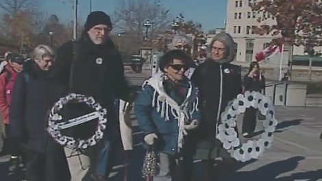 Pacifists lay wreaths adorned with white poppies at the National War Memorial, Thursday, Nov. 11, 2010