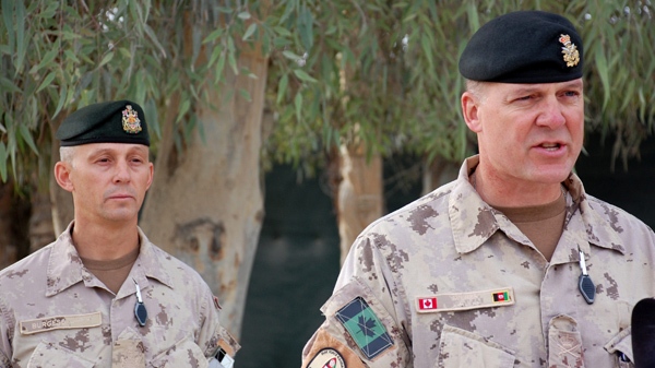 Canadian Brig.-Gen. Dean Milner, right, announces that Cpl. Steve Martin, 24, a member of the 3rd Battalion Royal 22e Regiment, was killed Saturday following a bomb blast in the vicinity of a major road construction project in Kandahar, Afghanistan on Sunday Dec. 19, 2010. Chief Warrant Officer Kirby Burgess, the regimental sergeant major for Task Force Kandahar, looks on. (Murray Brewster / THE CANADIAN PRESS)