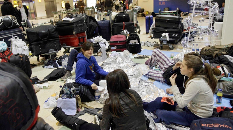 Passengers are seen in the Terminal 1 at Heathrow Airport in London, as they wait for their flights, most of which were canceled due to severe weather which hit Britain on last weekend, on Monday, Dec. 20, 2010. (AP / Ivan Sekretarev)