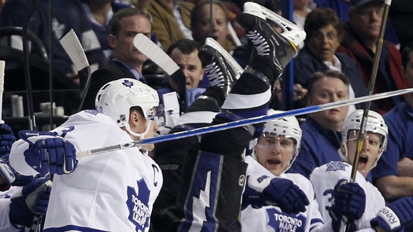 Toronto Maple Leafs defenseman Dion Phaneuf (3) sends Tampa Bay Lightning center Dana Tyrell (42) into the Maple Leafs bench after a check during the first period of an NHL hockey game in Tampa, Fla., Tuesday, Jan. 25, 2011.(AP Photo/Chris O'Meara)