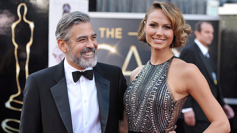 George Clooney, left, and Stacy Keibler arrive at the Oscars at the Dolby Theatre in Los Angeles on Sunday Feb. 24, 2013. (John Shearer / Invision)