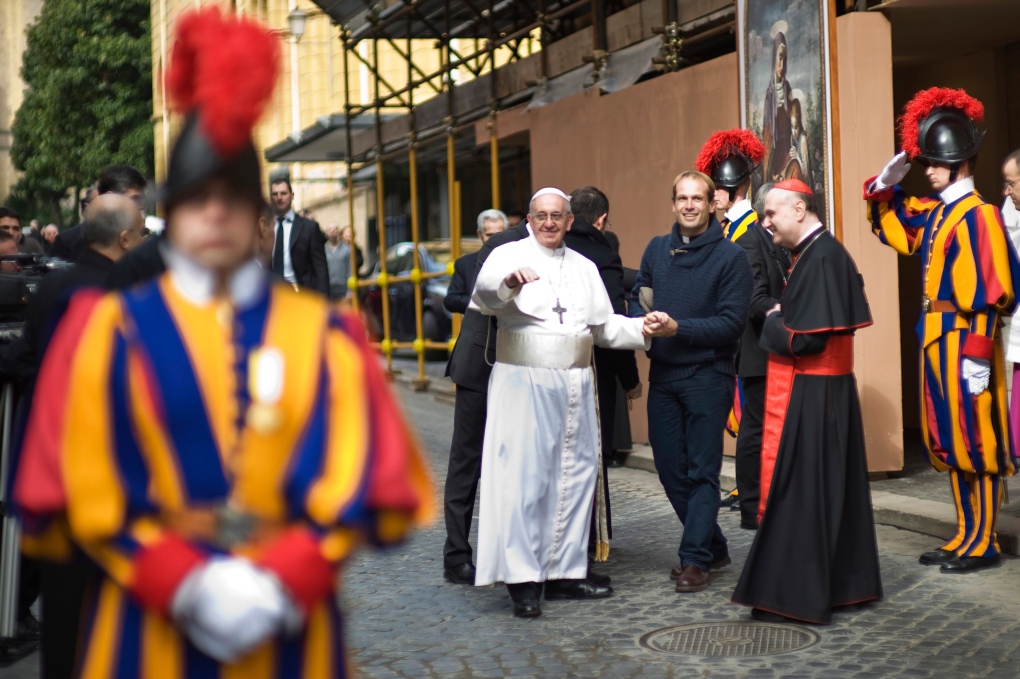 Pope Francis is flanked by Uruguay's priest Gonzal