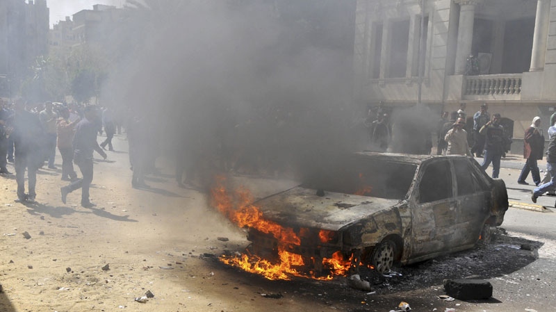 A fire set in a car believe to be set by hundreds of low-ranking police near the security headquarters in Cairo, Egypt, Wednesday, Feb.23, 2011, after four days of protests to demand better salaries. (AP Photo/Hossam Khalil)