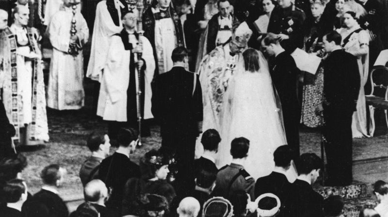 Bridegroom Philip Mountbatten (Duke of Edinburgh), right centrr, places the wedding ring on the bride's (Princess Elizabeth) finger at Westminster Abbey, Nov. 20, 1947 (AP)