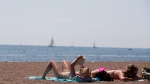People read as they sunbathe on a warm summer day at Cherry Beach in Toronto on Thursday, Aug. 23, 2012. (The Canadian Press/Michelle Siu)