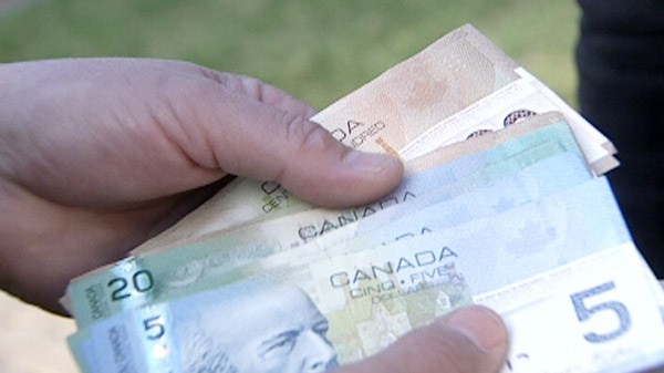 The lost cash found along a roadway is seen in Ingersoll, Ont. on Wednesday, April 13, 2011.