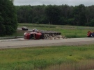 A garbage truck rollover on Highway 402 at Oil Heritage Road north of Petrolia, Ont. is seen on Friday, June 28, 2013. (Bryan Bicknell / CTV London)