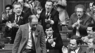 Prime Minister Pierre Trudeau gets a rousing cheer from his cabinet members after a vote in favour of passage of the constitution 246-24 in the House of Commons in Ottawa, Dec. 2, 1981. (Andy Clark / THE CANADIAN PRESS)