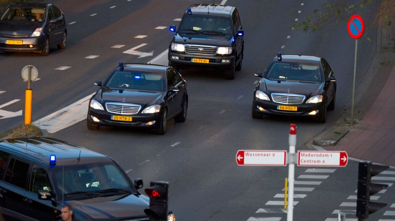 A helicopter-escorted convoy of police vehicles with flashing blue lights possibly carrying Ratko Mladic arrives at the detention centre in Scheveningen, Netherlands, Tuesday, May 31, 2011. (AP / Hugo de Hertog)
