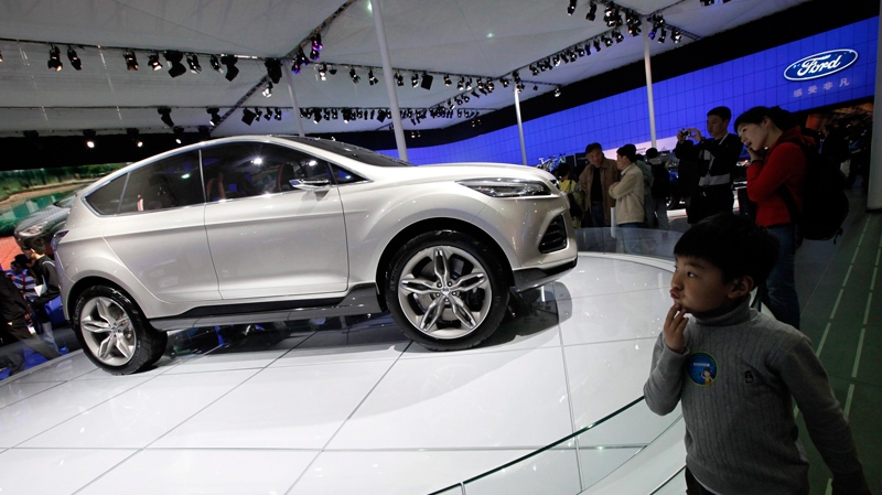 Visitors look at a Ford Vertrek Concept car at the Shanghai International Auto Show Thursday, April 21, 2011 in Shanghai, China. (AP / Eugene Hoshiko)