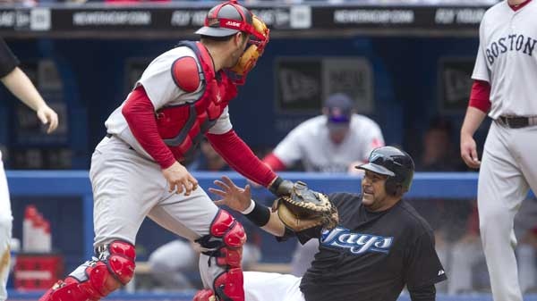 Toronto Blue Jays' Jose Molina, right, slides safely to score in front of Boston Red Sox catcher Jason Varitek during fourth inning MLB baseball action against in Toronto Saturday, June 11, 2011. (Darren Calabrese / THE CANADIAN PRESS)