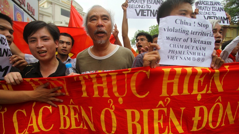 Vietnamese protesters carry a banner with a Vietnamese slogan reading, 'China must respect and execute the Declaration on the Conduct of Parties in the South China Sea,' during a protest in Hanoi, Vietnam on Sunday, June 12, 2011. (AP / Na Son Nguyen)