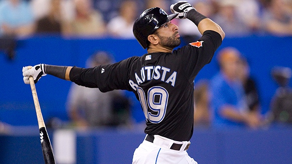 Toronto Blue Jays' Jose Bautista watches the flight of the ball as he flies out to right against Texas Rangers during the eigth inning of MLB baseball action in Toronto on Friday July 29, 2011. (THE CANADIAN PRESS/Chris Young)