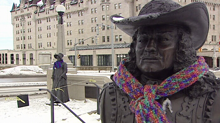 Statues in the Valiants Memorial decorated with scarves for the needy.