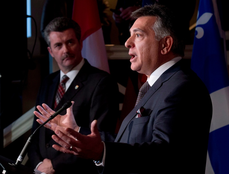 Ontario Finance Minister Charles Sousa speaks as Prince Edward Island Finance Minister Wes Sheridan looks on following federal-provincial Finance ministers meetings Monday December 16, 2013 in Chelsea, Que. (Adrian Wyld/THE CANADIAN PRESS)