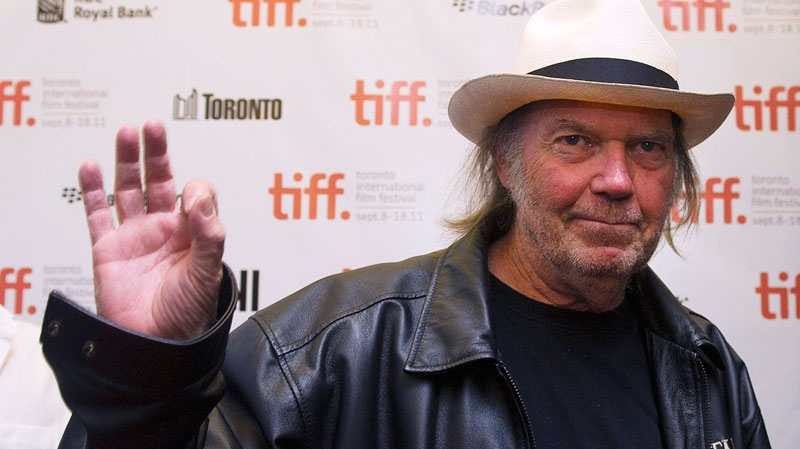 Neil Young waves as he arrives for new movie 'Neil Young Journeys' at the Toronto International Film Festival in Toronto on Monday, Sept., 12, 2011. (Nathan Denette / THE CANADIAN PRESS)     