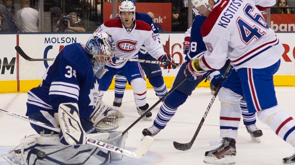 Toronto Maple Leafs goaltender James Reimer (left) saves as shot from Montreal Canadiens' Andrei Kostitsyn (right) during first period NHL hockey action in Toronto on Thursday October 6, 2011.THE CANADIAN PRESS/Chris Young