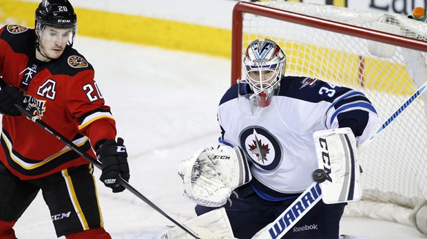 Rookie Hutchinson looking like an NHL goalie as Jets beat Flames 5-3 ...