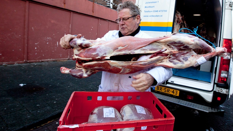 Ritually slaughtered lamb is delivered at a halal butcher shop in The Hague, Netherlands, Tuesday, Dec. 13, 2011. (AP / Peter Dejong)