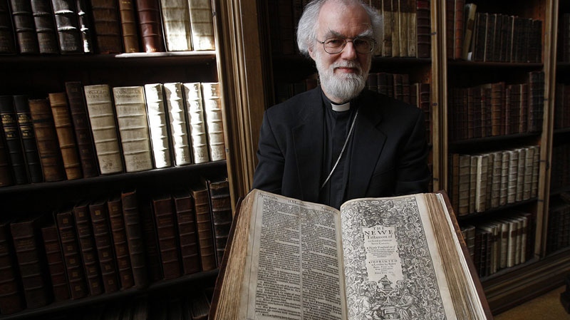 The Archbishop of Canterbury Dr Rowan Williams poses for photographers with the 400 year old King James Bible at Lambeth Palace Library's newest exhibition in London, Wednesday, May 25, 2011. Lambeth Palace Library's new exhibition 'Out of the Original Sacred Tongues', which is open until July 29, 2011, celebrates the 400th anniversary of the King James Version. 