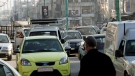 A picture of President Bashar Assad is seen as people walk the streets of the flashpoint city of Homs in central Syria, Thursday, Dec. 29, 2011, during a government-organized media tour. (AP / Bassem Tellawi)