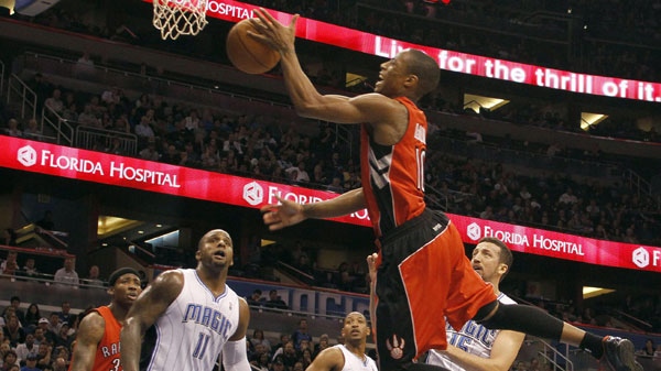 Toronto Raptors' Ed Davis (32) and Anthony Carter (25) and Orlando Magic's Glen Davis (11), Chris Duhon (25) and Hedo Turkoglu (15), of Turkey, watch as Raptors guard DeMar DeRozan (10) drives to the basket during the first half of an NBA basketball game, Sunday, Jan. 1, 2012, in Orlando, Fla. Orlando won 102-96. (AP Photo/Reinhold Matay)