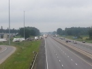 Vehicles are seen being diverted off Highway 401 near Ingersoll, Ont. after an early morning crash involving a car and a motorcycle on Wednesday, July 23, 2014. (Justin Zadorsky / CTV London)