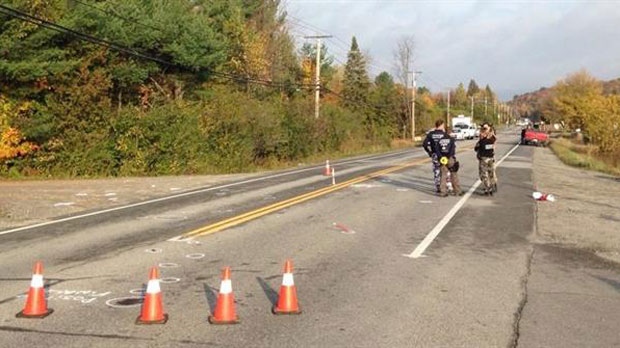 Police attend the scene in Cantley, Quebec, where a 17-year-old girl was struck and killed by a vehicle along Highway 307 on Tuesday, Oct. 14, 2014. (MRC des Collines)