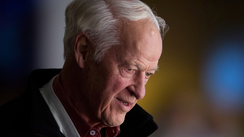 Hockey great Gordie Howe watches the Vancouver Canucks and San Jose Sharks play during an NHL hockey game in Vancouver, on Thursday, Nov. 14, 2013. (The Canadian Press/Darryl Dyck)