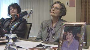 Barb Kilpatrick (left) and Betty Rowbotham speak to media on March 30, 2012 about the not-guilty verdict in the murder case for the death of their sister Bev Rowbotham. A picture of Bev is shown on the table. 