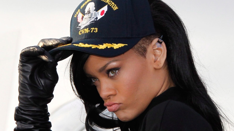 Rihanna poses with a USS George Washington cap during a photocall of a promotion event of her debut movie 'Battleship' aboard the aircraft carrier at the U.S. 7th Fleet's headquarters in Yokosuka, near Tokyo, Monday, April 2, 2012. (AP / Koji Sasahara)