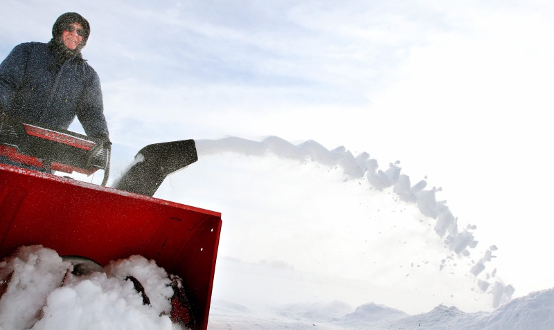 Using a snow blower Mel Fuglsang clears snow from the driveway of his rural home near Welton, Iowa on Tuesday, Jan. 6, 2015. (The Quad City Times, Kevin E. Schmidt / AP Photo)