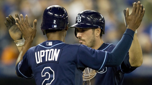 Tampa Bay Rays B.J. Upton and Matt Joyce celebrate after scoring on teammate Luke Scott's hit during fifth inning AL action against the Toronto Blue Jays in Toronto on Monday May 14, 2012. THE CANADIAN PRESS/Frank Gunn