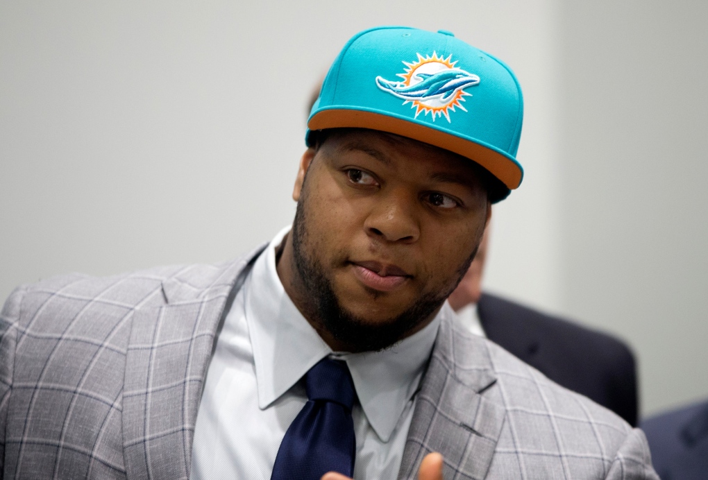 Former Detroit Lions star Ndamukong Suh runs with Warren Buffett