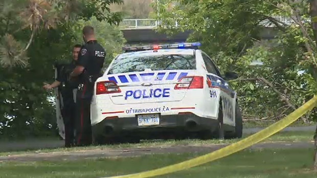 Ottawa Police attend the scene where the body of an unidentified man has been recovered from the Rideau River on Saturday, June 27, 2015.