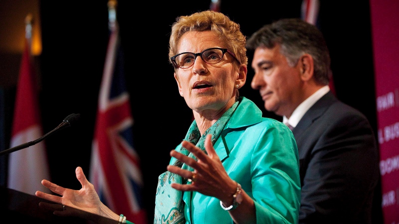 Ontario Premier Kathleen Wynne and Finance Minister Charles Sousa are shown in Toronto on Tuesday June 11, 2013. (Aaron Vincent Elkaim/THE CANADIAN PRESS)