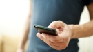 A man dials a cellphone. (Kostenko Maxim / shutterstock.com)