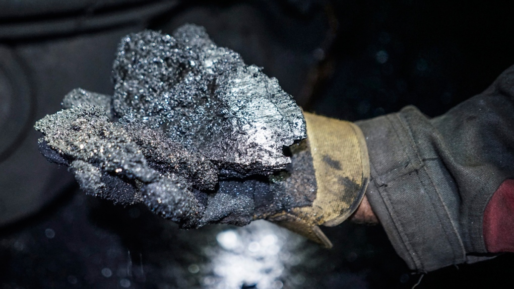A miner shows a lump of coal